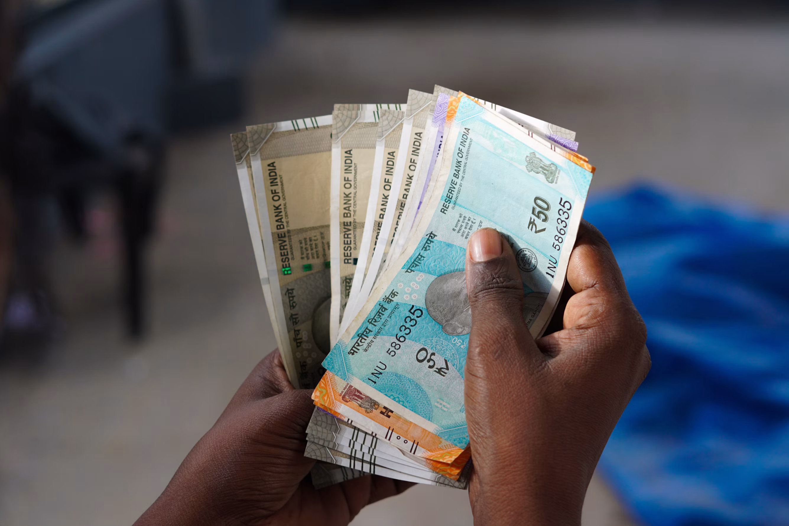 A person holding a bunch of money in their hand