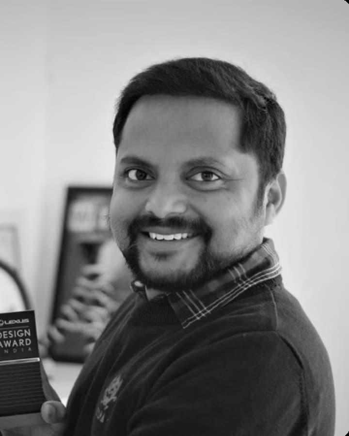Black and white portrait of Mani Teja smiling